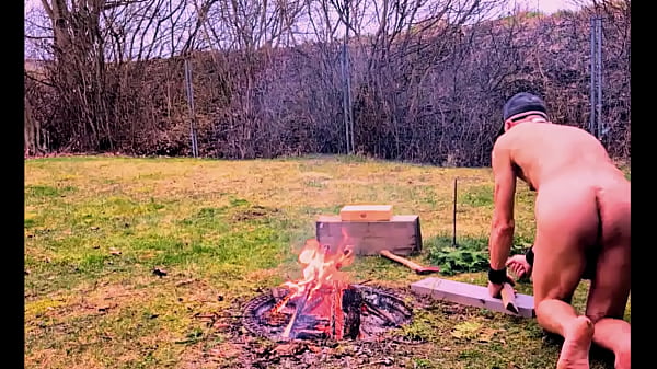 naked pathetic slave outdoor prepare campfire first time this year for BDSM party